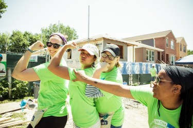 Women Builders flex after a hard day's work on the Habitat Chicago construction site