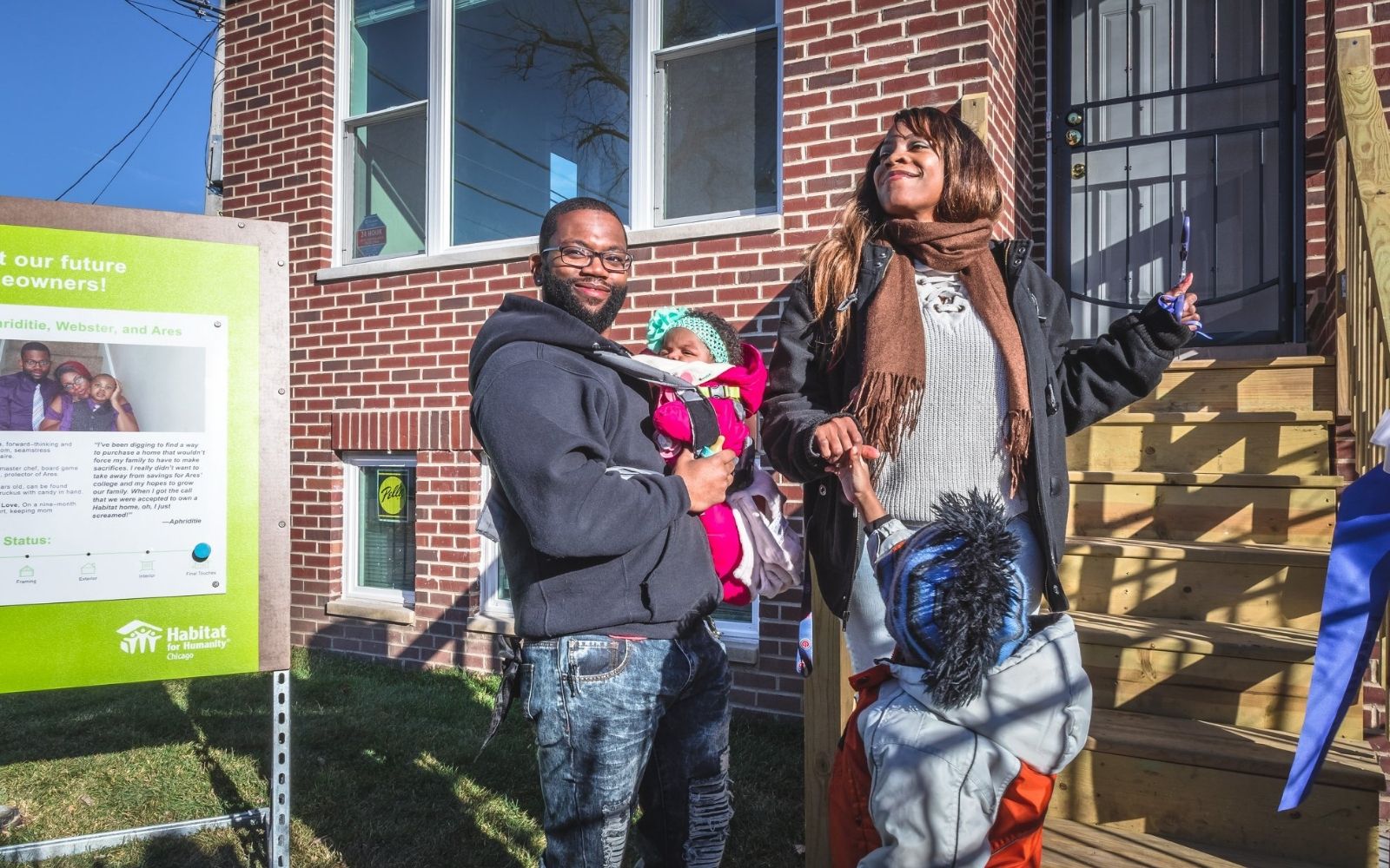 Family of four proudly walking towards new home