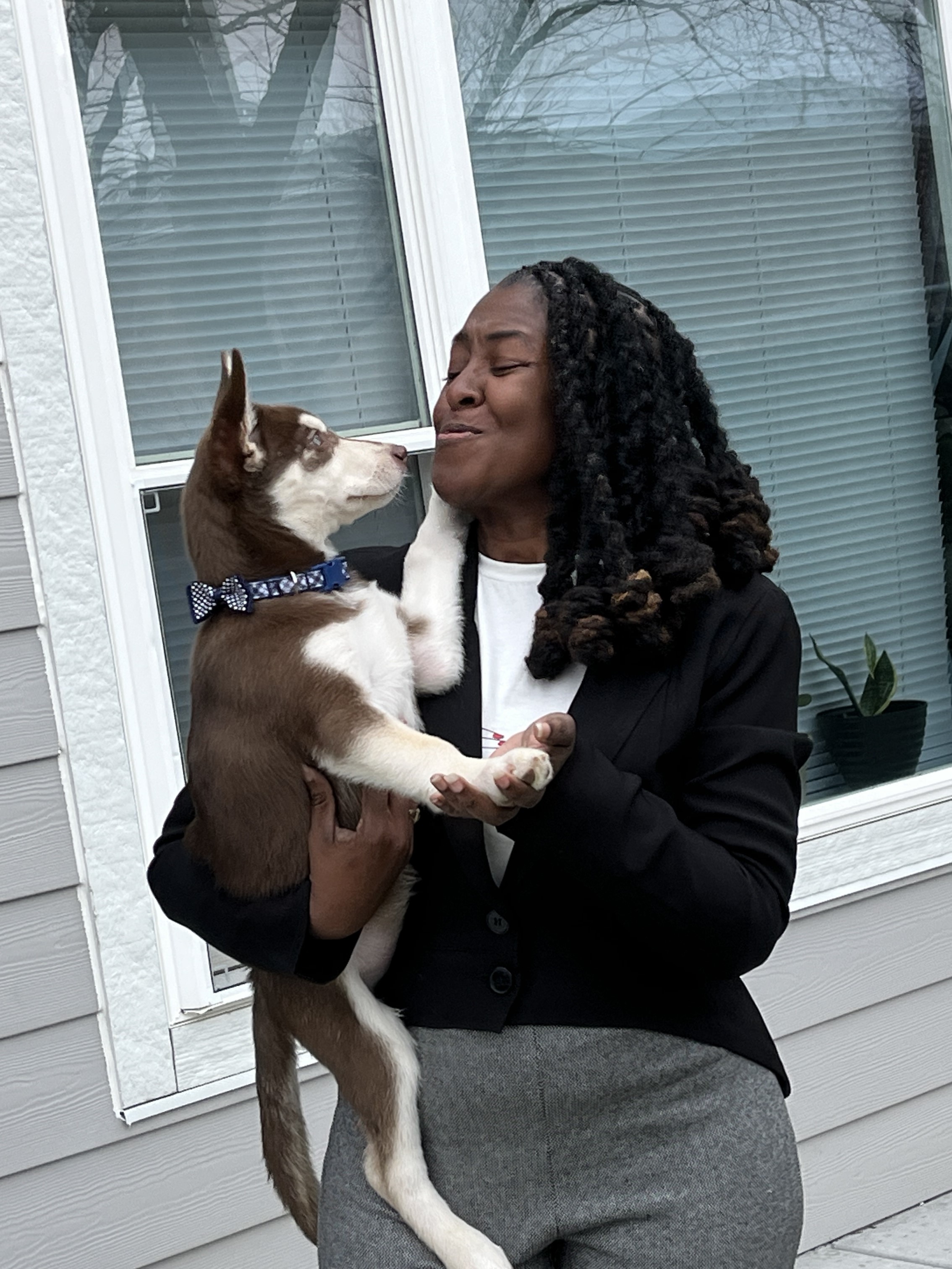 Woman holding her husky puppy