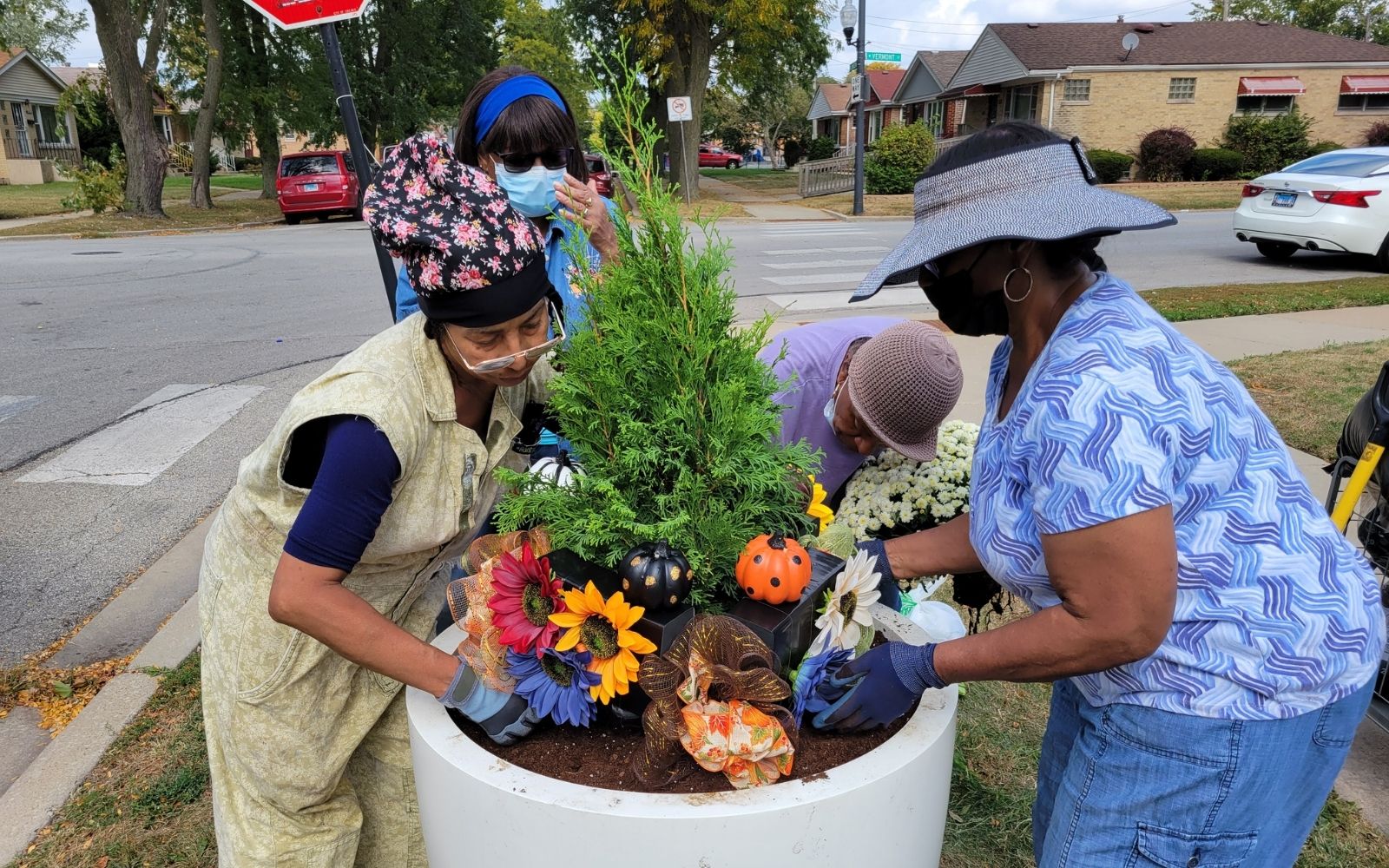 Neighbors decorating large planter display