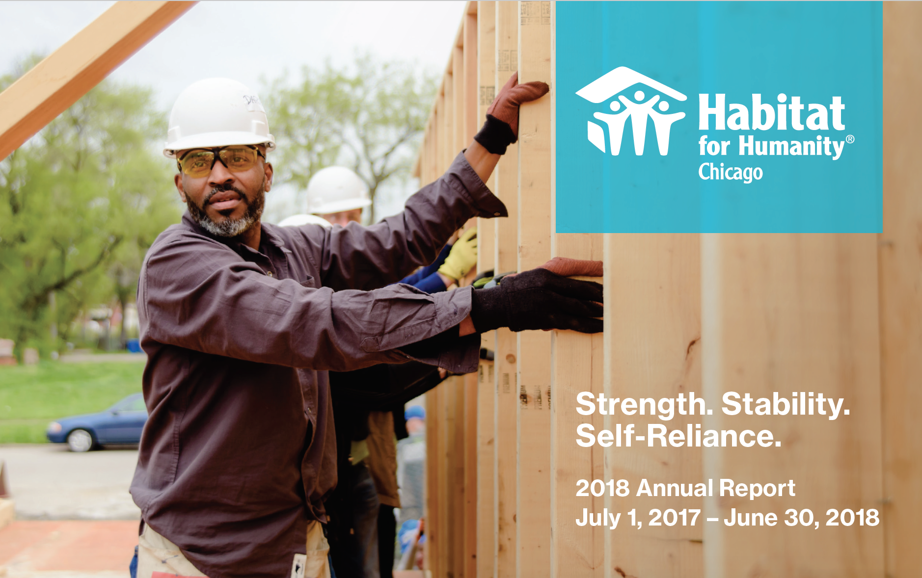 The cover of Habitat Chicago's 2018 Annual Report - A volunteer helps raising a wall on the Habitat Chicago build site