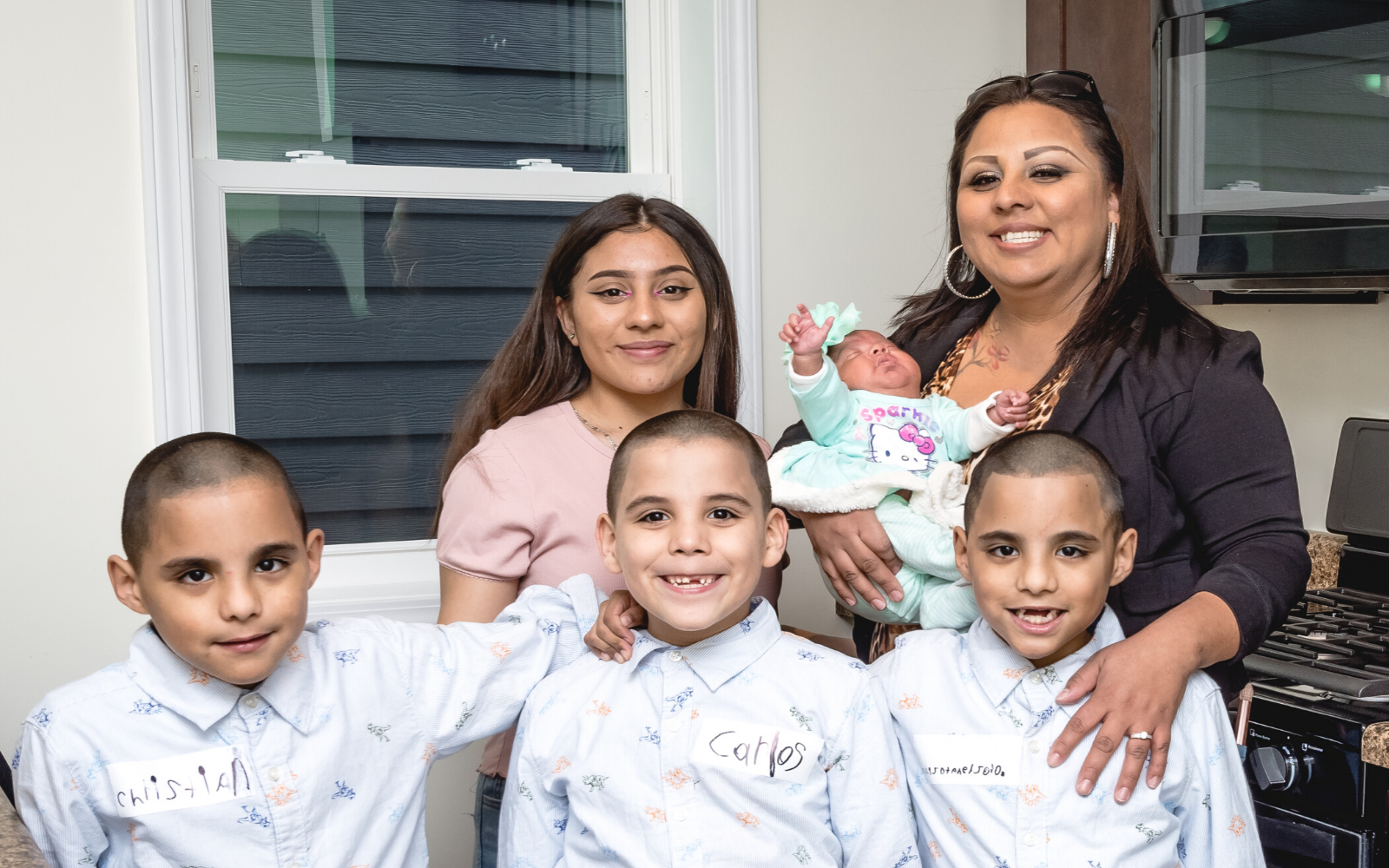 Habitat household smiling in their home