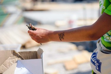 A Habitat Women Build volunteer shows off her temporary tattoo while gathering nails for a wall