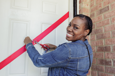 Proud homeowner cuts the ribbon on her new affordable Habitat home 