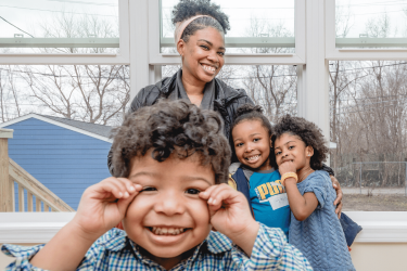 Happy family on the first day in their new affordable Habitat home