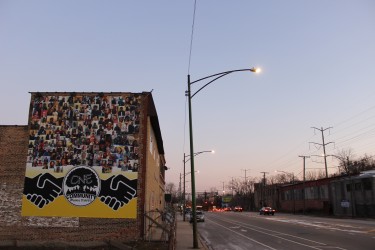 Community banner hanging on the side of a building in Greater Grand Crossing