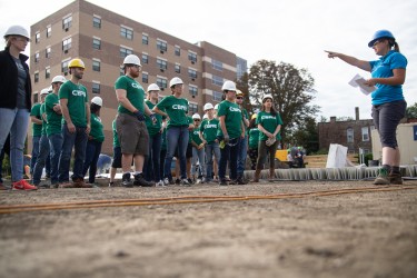 Corporate group receiving instructions on the build site