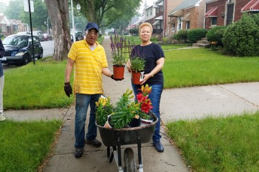 Neighbors Posing with Flowers for their Beautification Project