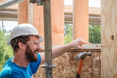 AmeriCorps Member Hammering on the Build Site