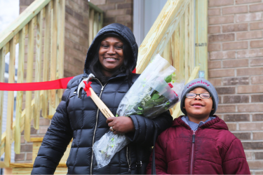 Darlene and her grandson on their home dedication day! 