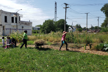 Neighbors work in community garden.