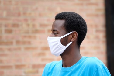 A volunteer supports Habitat Chicago wearing his mask to protect others and himself