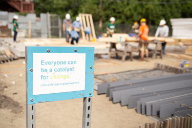 Sign at active construction site, reading "Everyone can be a catalyst for change."