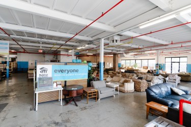 Showroom of couches and some tables; banner reads "everyone deserves a place to call home"