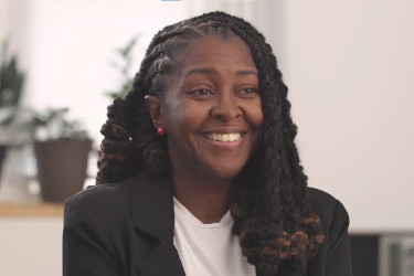 Woman smiling, looking off screen